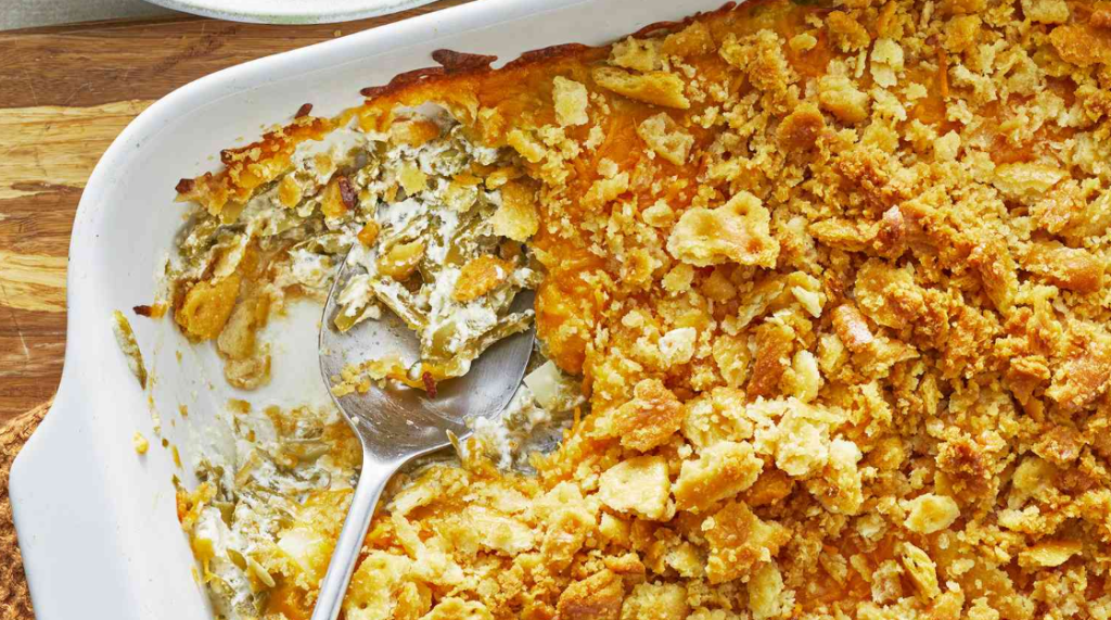 A freshly baked green bean casserole without cream of mushroom soup, presented in a rustic baking dish on a wooden table. The casserole is golden brow